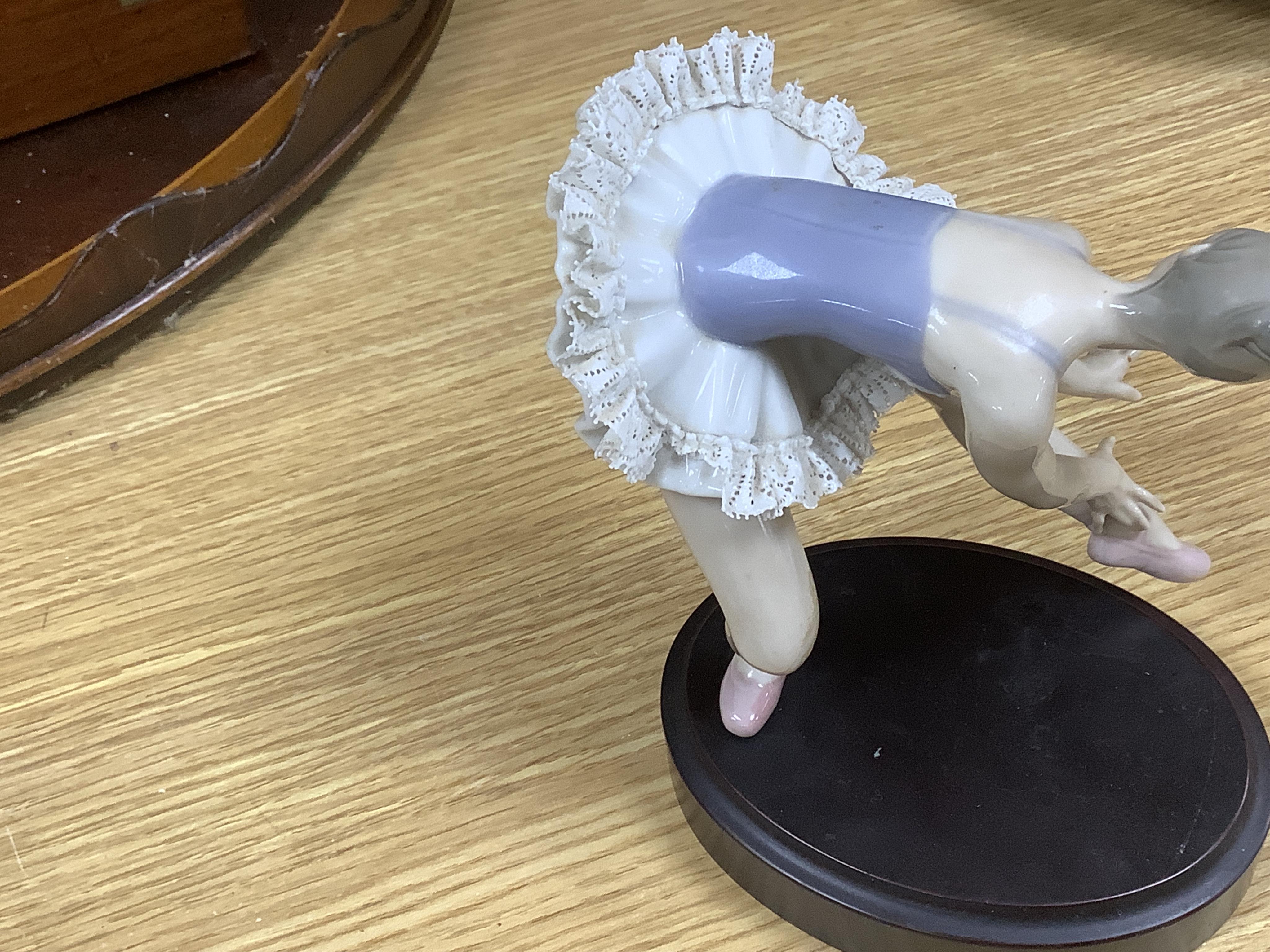 A large Lladro figure group of three ballet dancers by a tall floral column and eight other Lladro figures including a model of a bell. Tallest figure group 45cm high. Condition - golfer group, golf clubs broken.